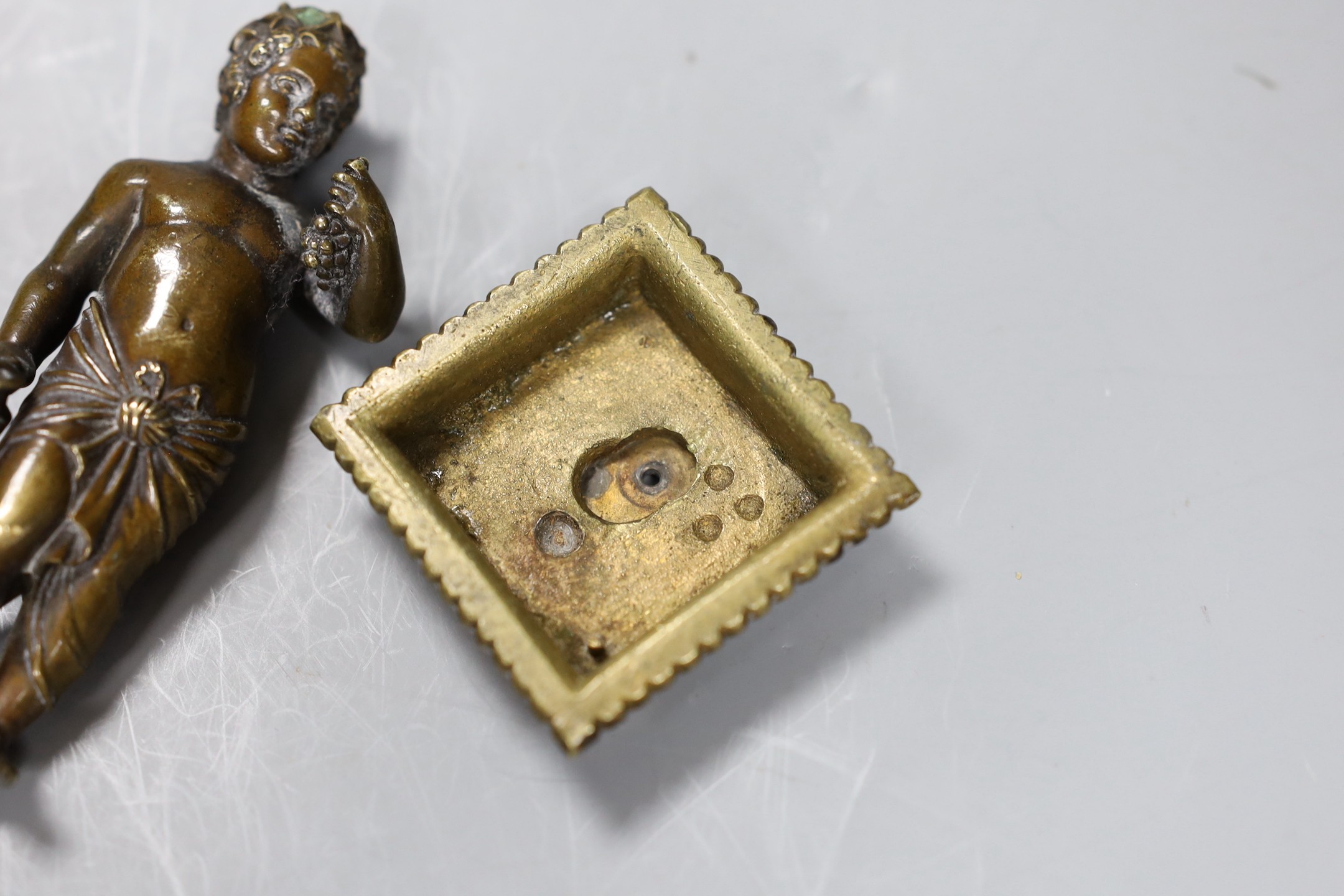 A 19th century Grand Tour souvenir bronze figure a Bacchanlian putti, 9cms high